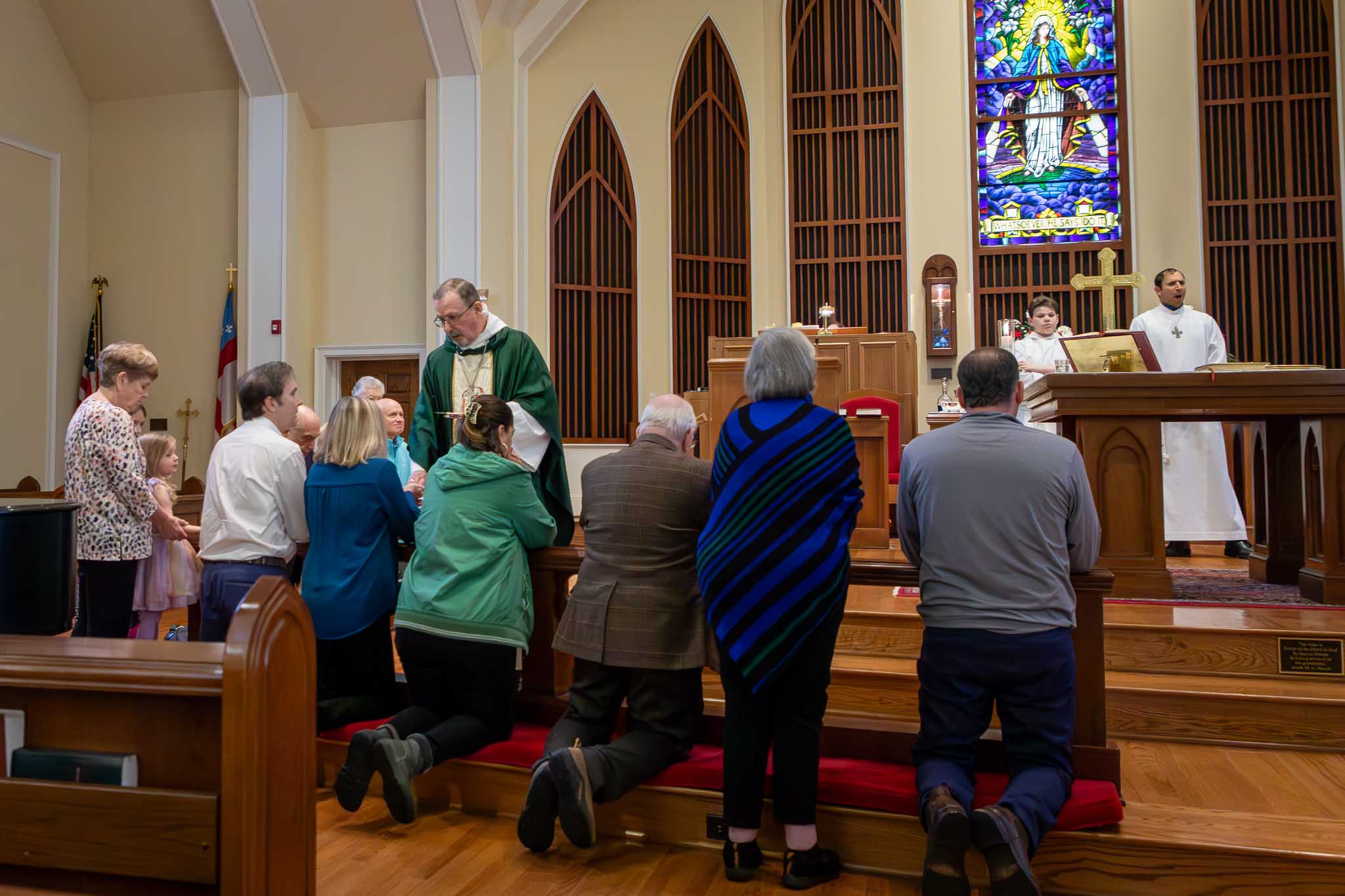 Minister serving Communion to parishioners.